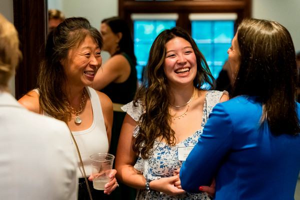 Student and parent smile during Emory event